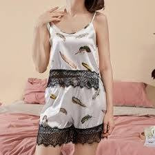 Two-piece women's pajama set featuring a camisole top and matching shorts.